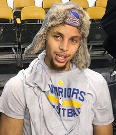 a man wearing a hat and sitting in a stadium