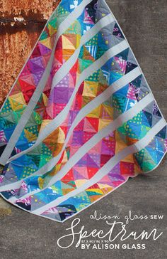 a colorful quilt hanging from the side of a building with text overlay that says,'free pattern madison glass '