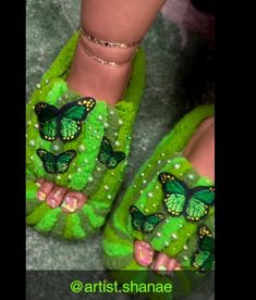 a pair of green slippers with butterflies on them