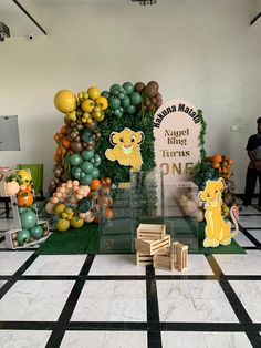 a table topped with lots of balloons and animals