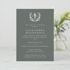 a gray and white wedding card with a wreath on it