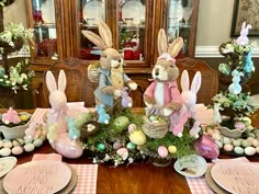 the table is set for easter with bunny decorations