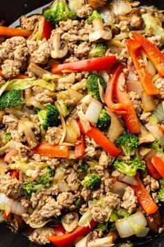 a skillet filled with meat and vegetables