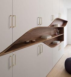 an unusual shelf in the middle of a room with books on it and other items