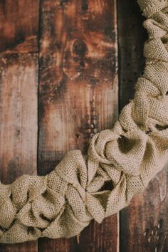 a close up of a rope wreath on a wooden wall