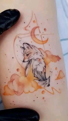 a woman's thigh with an artistic tattoo design on her leg and the image of a wolf