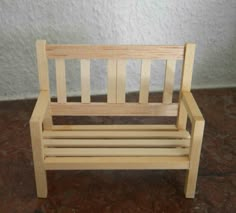 a wooden bench sitting on top of a brown floor