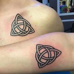 two men with matching tattoos on their arms