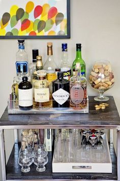 a bar cart filled with liquor bottles and glasses