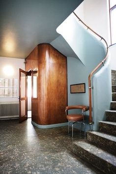 a room with stairs and a chair in it