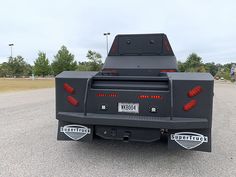 the back end of a pickup truck parked in a parking lot