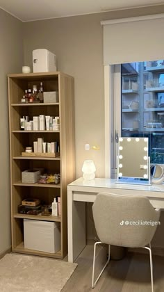 a room with a desk, mirror and shelves filled with personal care items in it