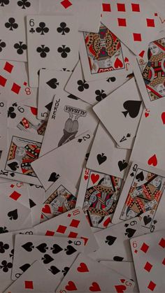 many playing cards are scattered on top of each other, including one in the middle