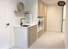 a washer and dryer in a small room with white walls, flooring and cabinets