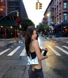 a woman standing in the middle of an empty street