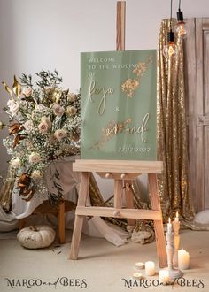 a wooden easel with a sign that says welcome to the wedding