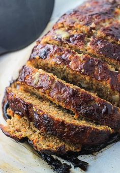 sliced meatloaf sitting on top of a cutting board