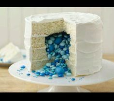 an image of a cake with blue and white frosting on the top, next to a book