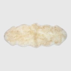 a white sheepskin rug on a gray background