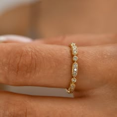 a woman's hand with a diamond ring on her left wrist, showing the band