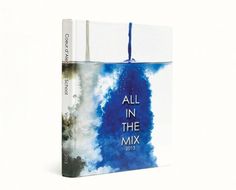 an all in the mix book on a white background with blue and grey clouds behind it