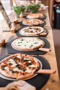 several pizzas are lined up on the table