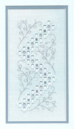 a cross stitch pattern with white flowers and blue trimmings on the bottom half of it