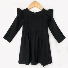 This gorgeous black linen dress can be worn all year long! It has flutter sleeves and long sleeves and closes with a zipper in back. Fits true to size. Casual Cotton Ruffle Dress With Ruffle Sleeves, Chic Cotton Dress With Elastic Sleeves, Casual Flowy Ruffle Dress For Fall, Chic Cotton Ruffle Sleeve Dress, Black Dresses With Ruffles And Butterfly Sleeves, Casual Cotton Dresses With Elastic Sleeves, Black Dress With Ruffles And Butterfly Sleeves, Elegant Cotton Dresses With Elastic Sleeves, Elegant Cotton Dress With Elastic Sleeves