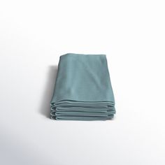 folded teal blue napkins on white background