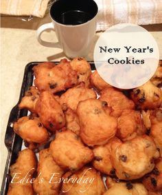 a tray filled with cookies next to a cup of coffee