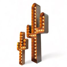 a large light up cactus sitting next to a smaller one with lights on it's sides