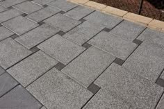 a close up view of a sidewalk made out of concrete blocks and cement pavers