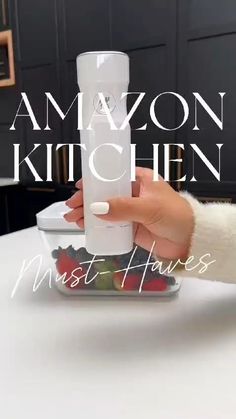 a person is holding an amazon kitchen blender in their hand and the words amazon kitchen must haves on it