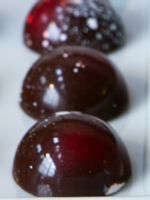 three chocolate covered fruits sitting on top of each other