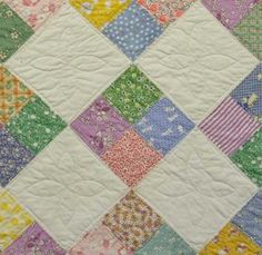 a quilt made with many different colored squares