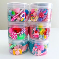 several plastic containers filled with different types of toys