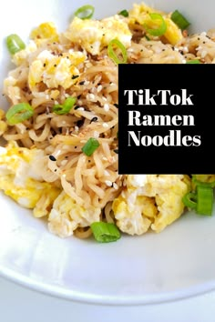 a white bowl filled with noodles and vegetables next to a black sign that says tik tok ramen noodles