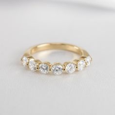 a yellow gold wedding band with five diamonds