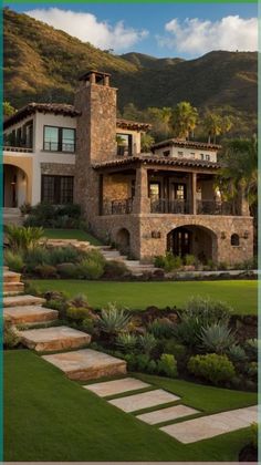 a house with steps leading up to it in the middle of grass and bushes on both sides