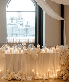 a table with candles and flowers on it