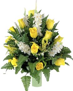 a bouquet of yellow roses and white flowers in a green vase with greenery on the side