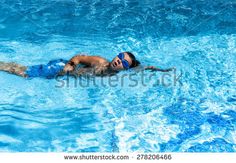 a man swimming in the pool with goggles on