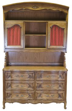 an old wooden dresser with red curtains on the top and bottom drawers, against a white background