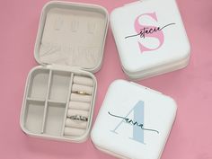 two personalized wedding rings are in an open box on a pink surface with the number four