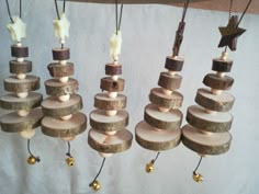 several wooden ornaments hanging from strings with bells