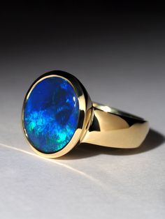 Black Opal 18K gold ring, could be a perfect engagement ring weight of the ring - 7.4 gr size of the opal gemstone - 11 x 13 mm opal weight - 4 ct size of the ring - 56 / 7.5 US / diameter 17 3/4, French size - 16  opal origin - Australia ref No 2466 Worldwide shipping from Berlin, Germany. Prices include all taxes, valid in Germany and in European Union countries on the Customer's order date. Price does not include import taxes and custom duties. It is the Customer's full liability to pay any p Rare Opal Ring, Engagement Rings Australia, Opal Gold Ring, Opal Jewellery, Gold Ring Engagement, Australian Opal Ring, Australian Black Opal, Black Opal Ring, Opal Band