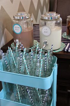 there are many empty glass bottles with drinking straws in them on the table next to each other