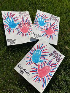 three handprinted fourth of july bags on the grass