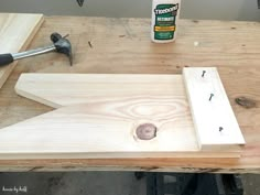 a table with some tools on top of it and a bottle of glue next to it