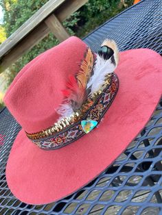 Orange felt hat, painted with rose gold acrylic paint flowers along the bottom rim, used feathers from my sisters farm (turkey, pheasant, and parrot). Two ribbons one vintage style and one gold stretchy along with a shinny crystal - Angelique J Bohemian Gold Hat For Kentucky Derby, Gold Bohemian Hat For Kentucky Derby, Red Bohemian Hat For Kentucky Derby, Bohemian Red Hats For Kentucky Derby, Bohemian Red Hat For Kentucky Derby, Bohemian Gold Party Hat, Gold Bohemian Party Hat, Bohemian Fedora Hat Band With Feather Trim, Bohemian Hat Band With Feather Trim